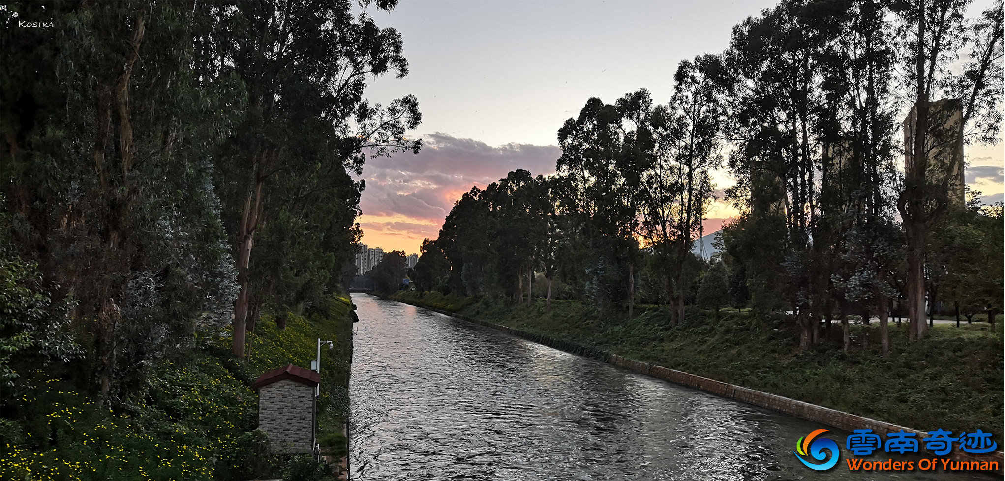 Evening vibe on a bridge view over Panlong river with the sunset in the background with trees and flowers alongside 