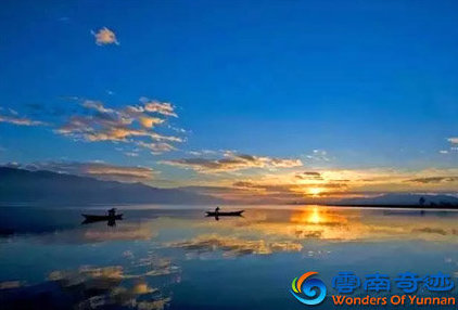 sunset at qilu lake with boats on the lake yuxi yunnan china