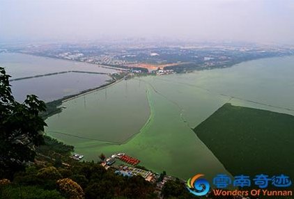 View from Dragon Gate Western Hills over Dianchi Lake green from pollution, Kunming, Yunnan, China