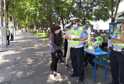 Chinese police enforcing law wear helmet on the scooter in Kunming