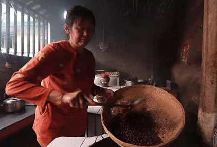 woman processing coffee beans