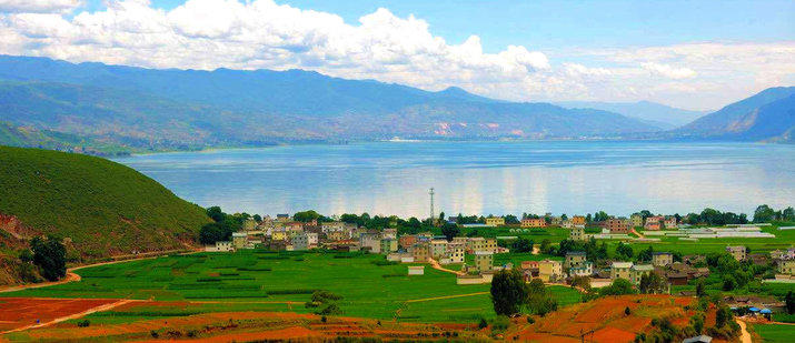 lake village and mountain view of chenghai lake in jinsha river valley lijiang yunnan china