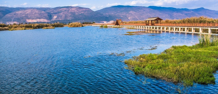 Yilong lake clear water wooden bridge honghe yunnan china